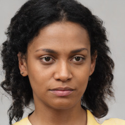 Neutral black young-adult female with medium  brown hair and brown eyes