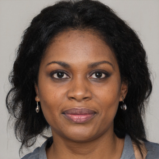 Joyful black young-adult female with medium  black hair and brown eyes