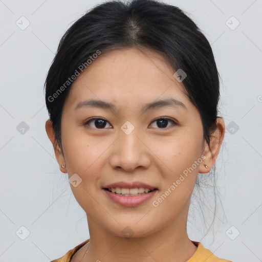 Joyful asian young-adult female with short  black hair and brown eyes