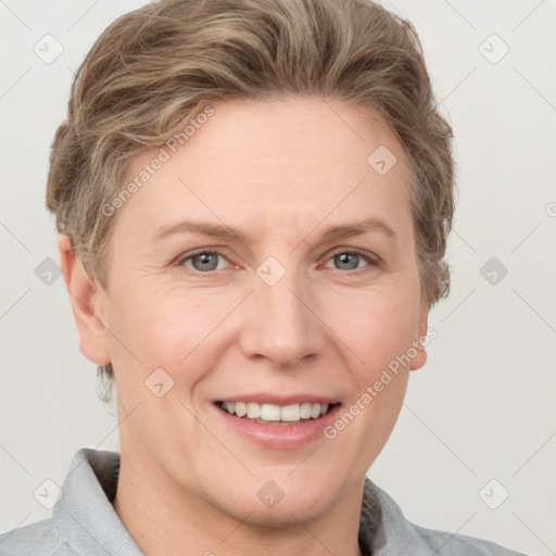 Joyful white adult female with short  brown hair and grey eyes