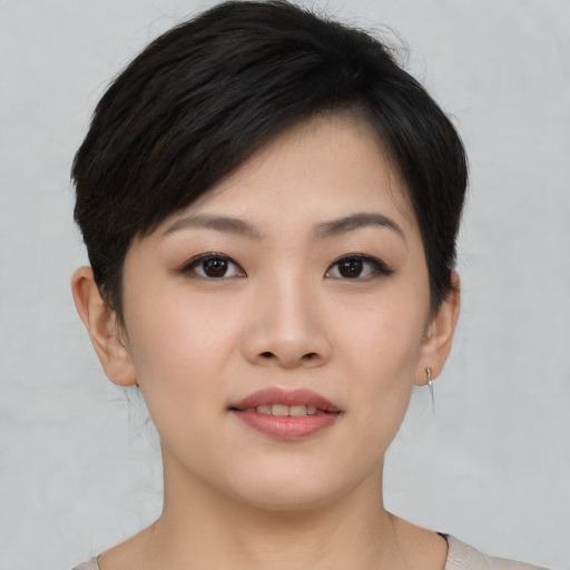 Joyful asian young-adult female with short  brown hair and brown eyes
