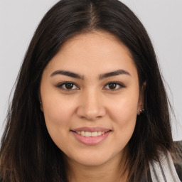 Joyful white young-adult female with long  brown hair and brown eyes