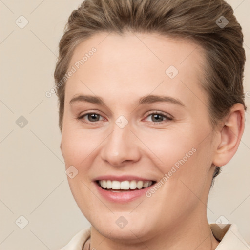 Joyful white young-adult female with short  brown hair and brown eyes