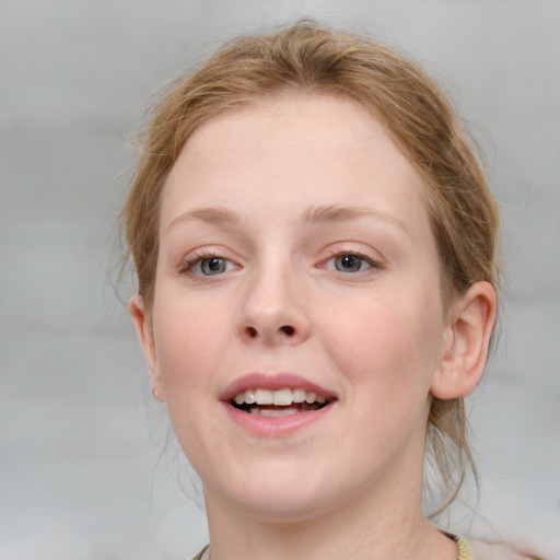 Joyful white young-adult female with medium  brown hair and blue eyes