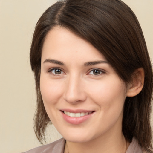 Joyful white young-adult female with medium  brown hair and brown eyes