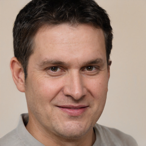 Joyful white adult male with short  brown hair and brown eyes