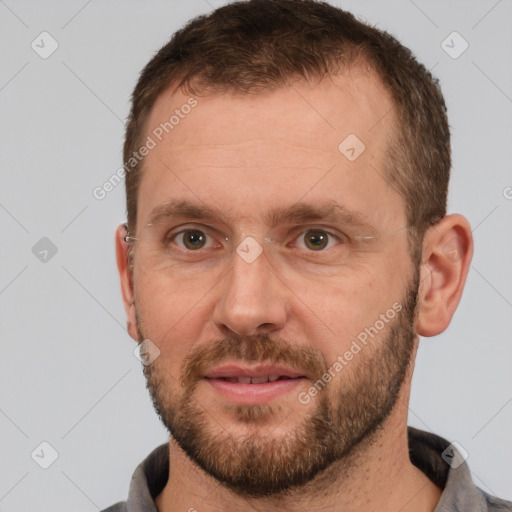 Joyful white adult male with short  brown hair and brown eyes