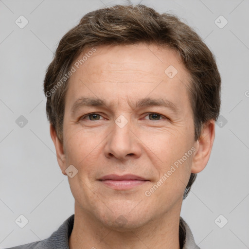 Joyful white adult male with short  brown hair and grey eyes