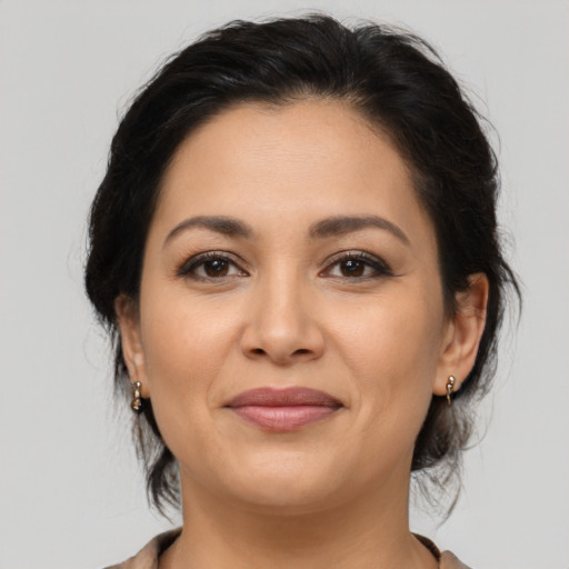 Joyful latino young-adult female with medium  brown hair and brown eyes