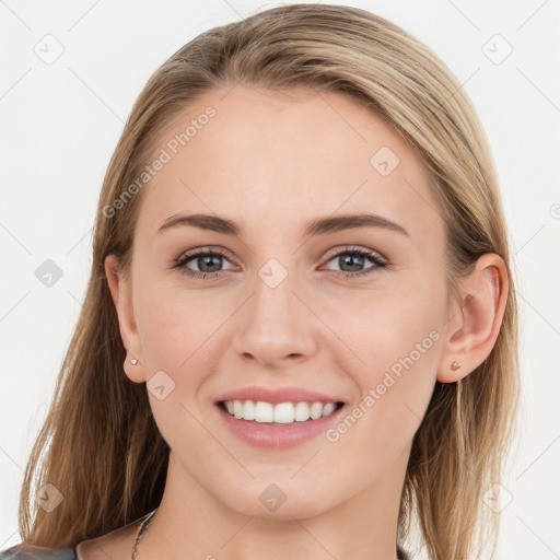 Joyful white young-adult female with long  brown hair and blue eyes