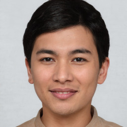 Joyful asian young-adult male with short  brown hair and brown eyes