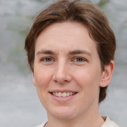 Joyful white adult female with short  brown hair and grey eyes