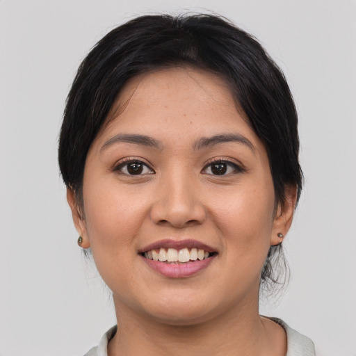 Joyful asian young-adult female with medium  brown hair and brown eyes