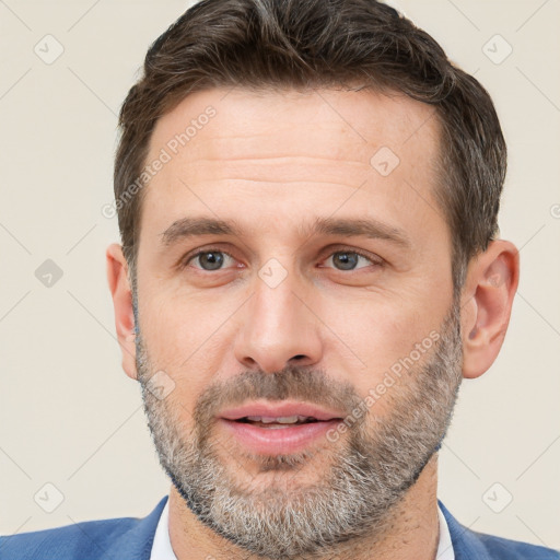 Joyful white adult male with short  brown hair and brown eyes