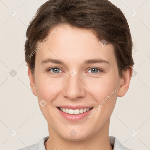 Joyful white young-adult female with short  brown hair and grey eyes