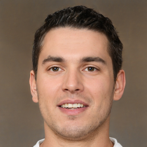 Joyful white young-adult male with short  brown hair and brown eyes