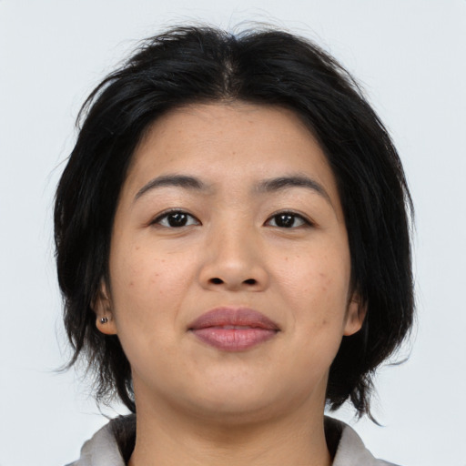 Joyful asian young-adult female with medium  brown hair and brown eyes