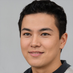 Joyful asian young-adult male with short  black hair and brown eyes