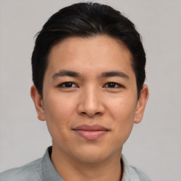 Joyful asian young-adult male with short  black hair and brown eyes