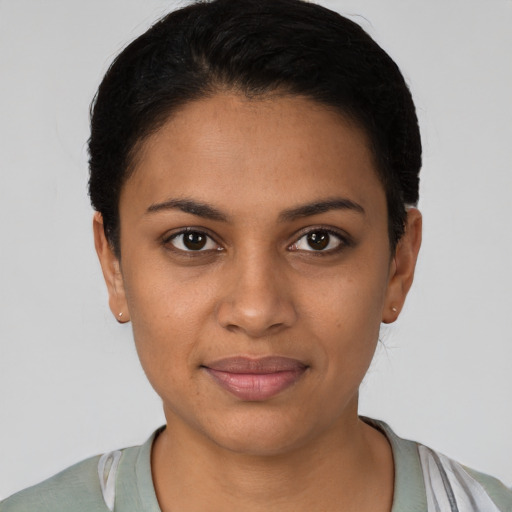 Joyful latino young-adult female with short  black hair and brown eyes