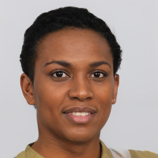 Joyful black young-adult female with short  brown hair and brown eyes