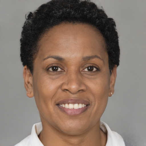 Joyful black adult female with short  brown hair and brown eyes