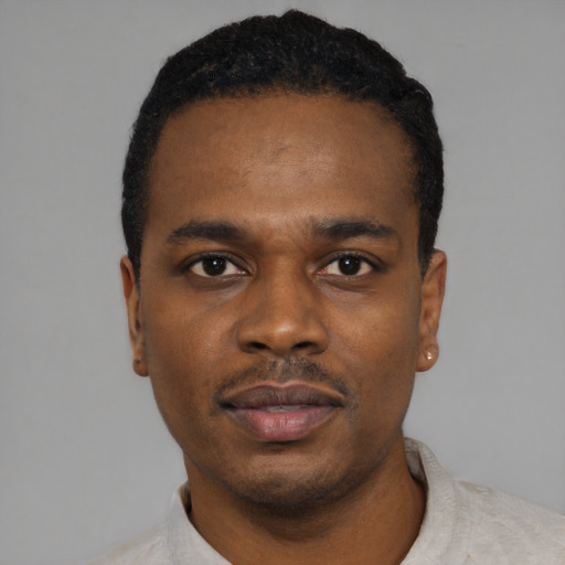 Neutral black young-adult male with short  black hair and brown eyes