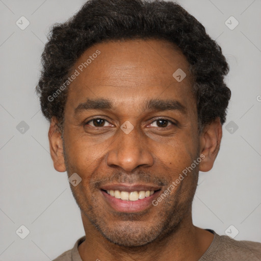 Joyful black adult male with short  black hair and brown eyes