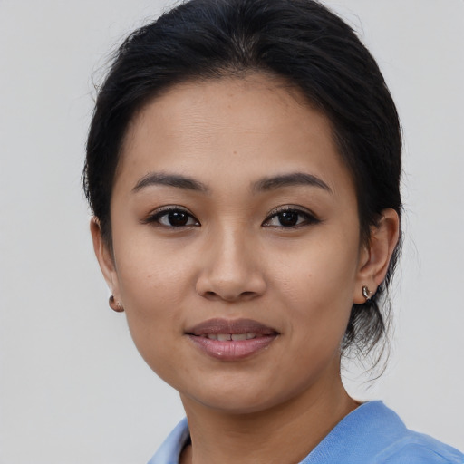 Joyful asian young-adult female with medium  brown hair and brown eyes