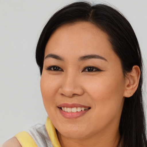 Joyful asian young-adult female with long  brown hair and brown eyes