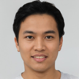 Joyful asian young-adult male with short  black hair and brown eyes