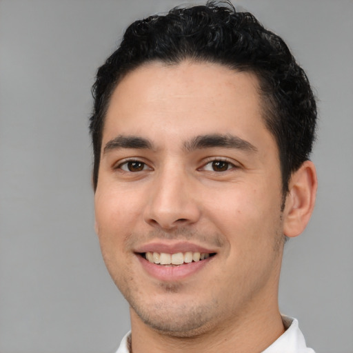 Joyful white young-adult male with short  black hair and brown eyes