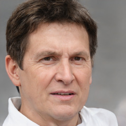 Joyful white middle-aged male with short  brown hair and brown eyes