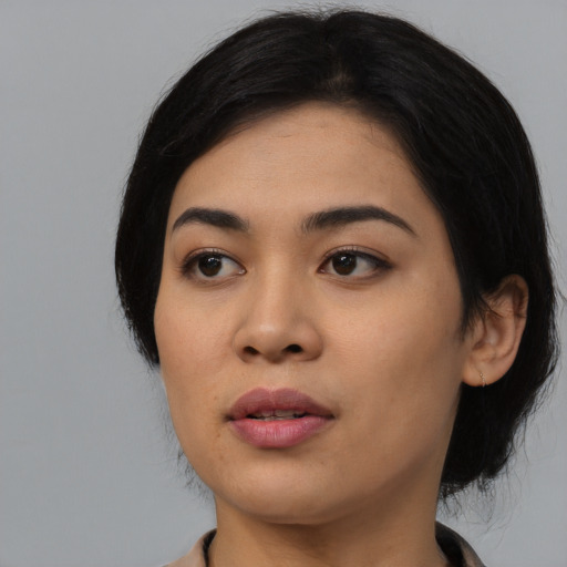Joyful asian young-adult female with medium  black hair and brown eyes