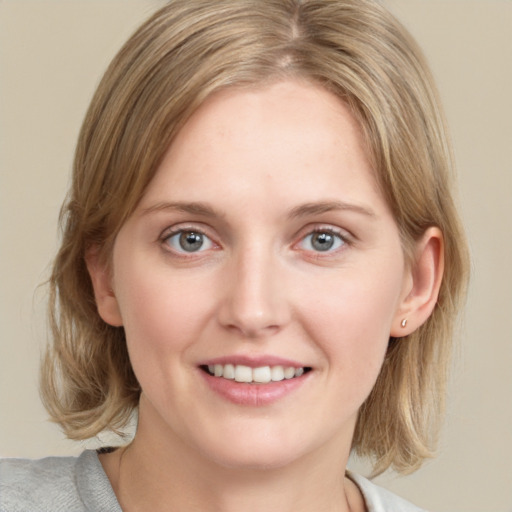 Joyful white young-adult female with medium  brown hair and blue eyes