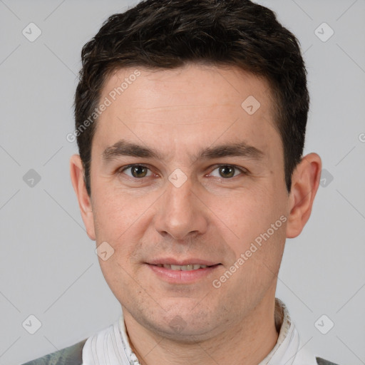 Joyful white adult male with short  brown hair and brown eyes