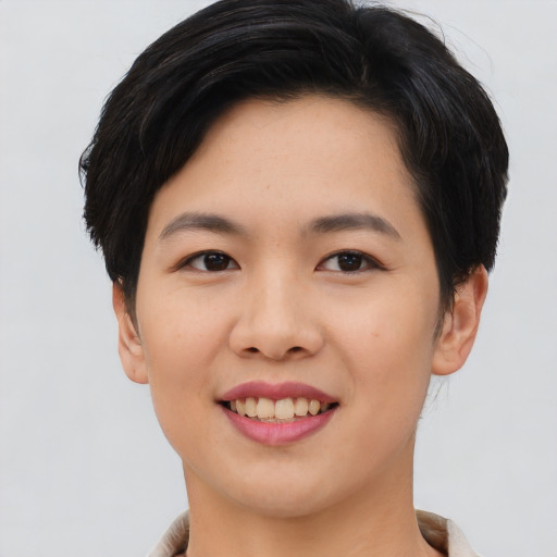 Joyful asian young-adult female with short  black hair and brown eyes