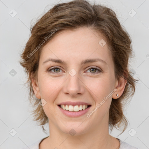 Joyful white young-adult female with medium  brown hair and green eyes