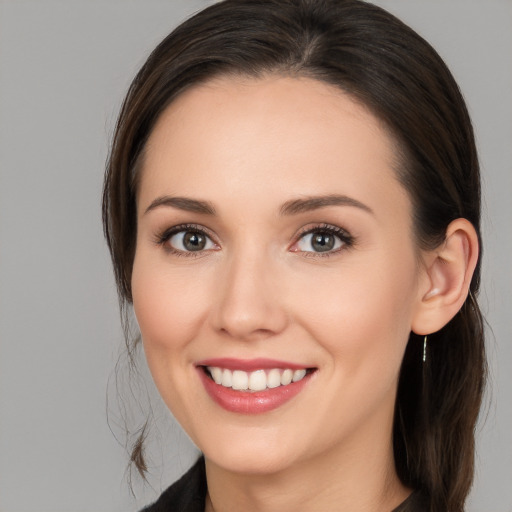 Joyful white young-adult female with medium  brown hair and brown eyes