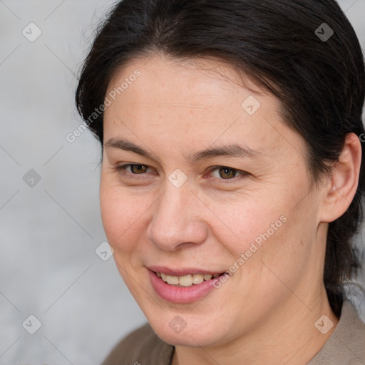 Joyful white adult female with medium  brown hair and brown eyes