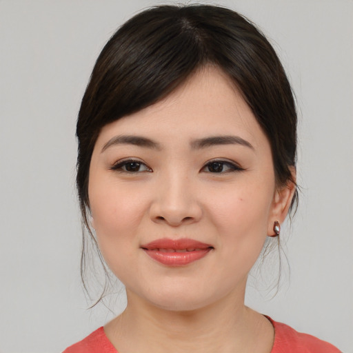 Joyful asian young-adult female with medium  brown hair and brown eyes