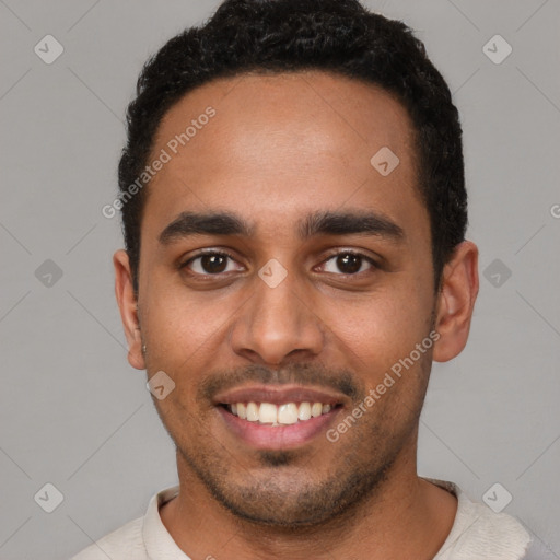 Joyful latino young-adult male with short  brown hair and brown eyes