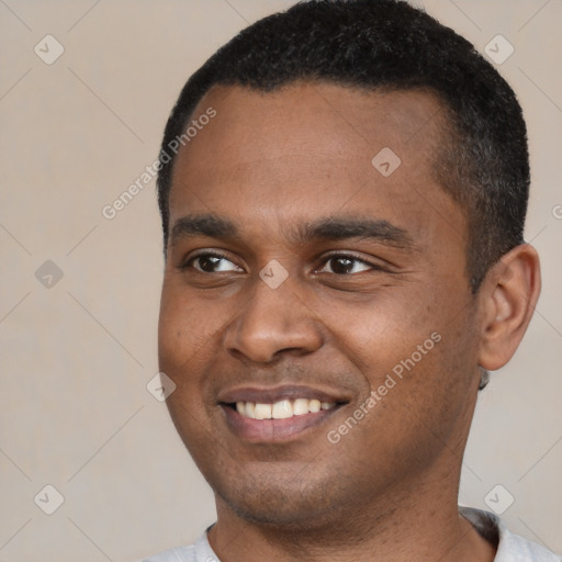 Joyful black young-adult male with short  black hair and brown eyes