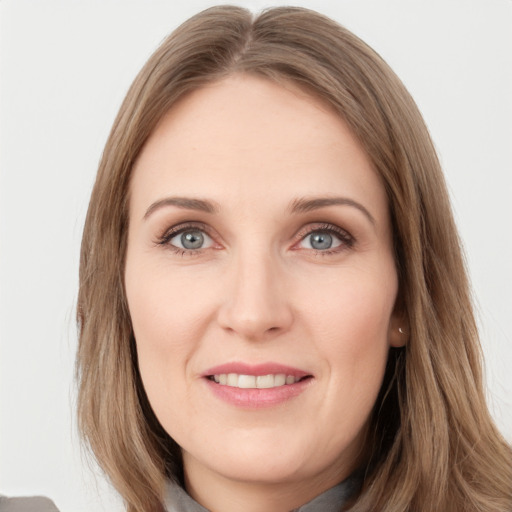 Joyful white young-adult female with long  brown hair and grey eyes