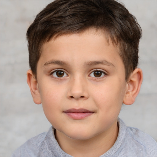 Joyful white child male with short  brown hair and brown eyes