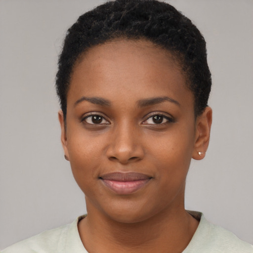 Joyful black young-adult female with short  black hair and brown eyes