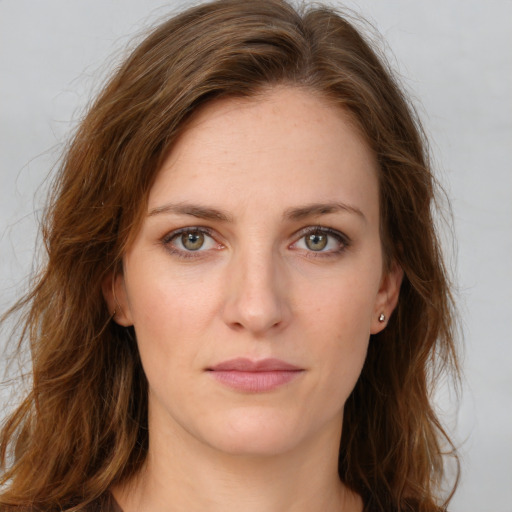 Neutral white young-adult female with long  brown hair and green eyes