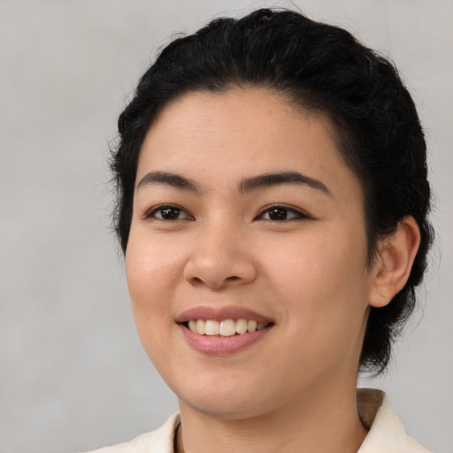 Joyful latino young-adult female with medium  black hair and brown eyes