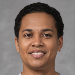 Joyful latino young-adult male with short  brown hair and brown eyes