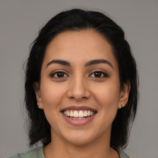 Joyful latino young-adult female with medium  black hair and brown eyes